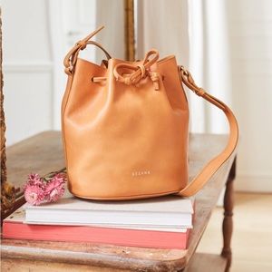 Sézane Farrow bag in natural, stains at the bottom, leather is stiff.